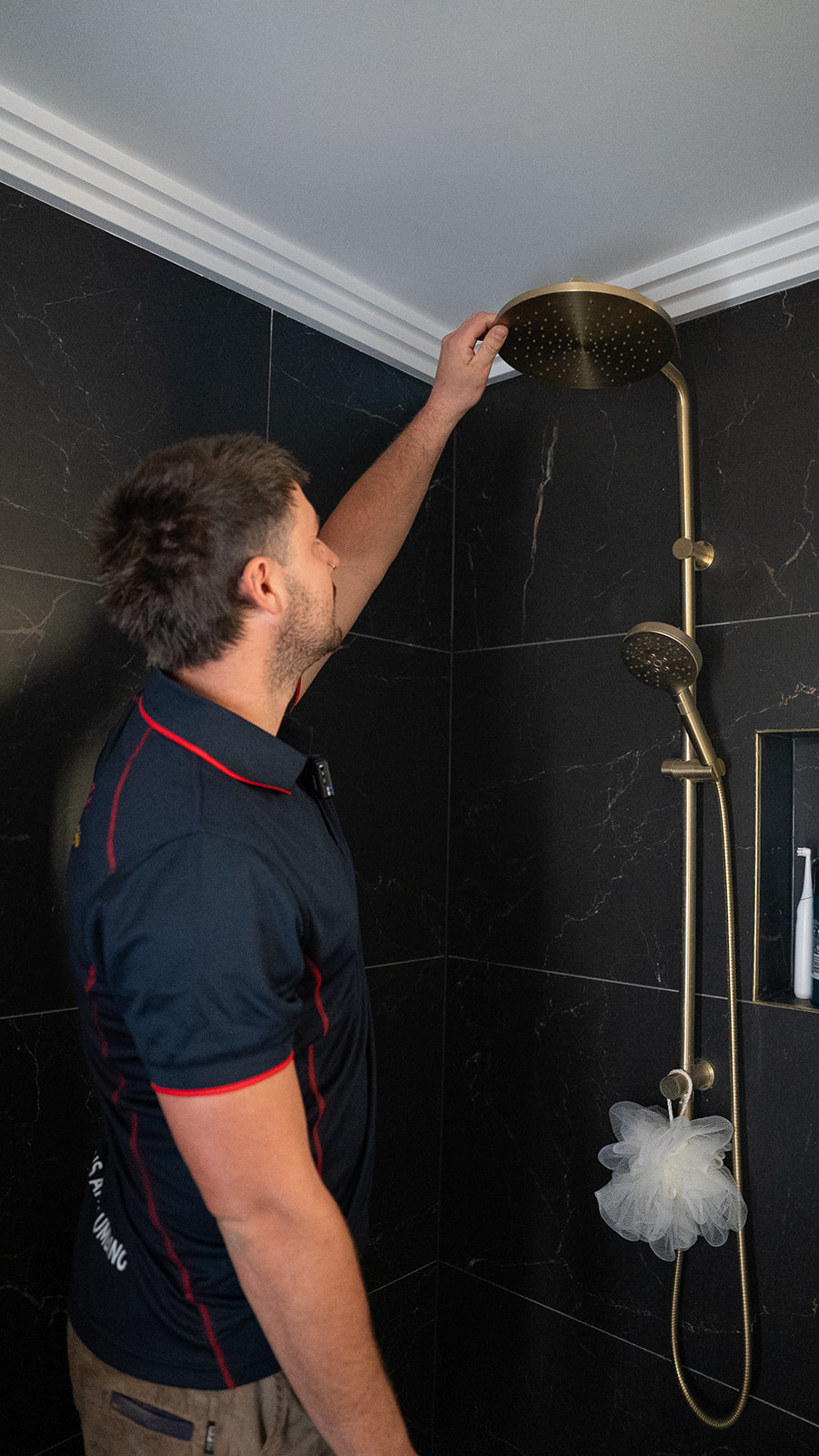 Shower head being fitted in a Sydney bathroom