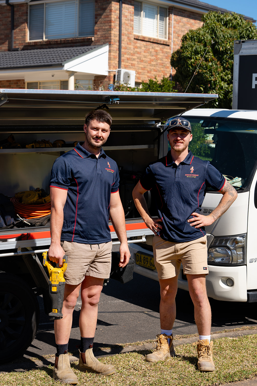 Two Fixed Today plumbers at the work truck